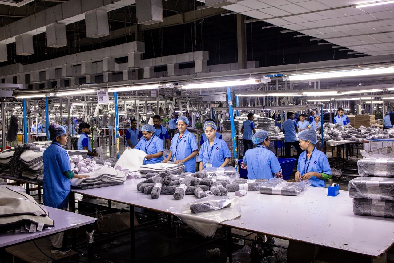 A textile factory with workers inspecting products.